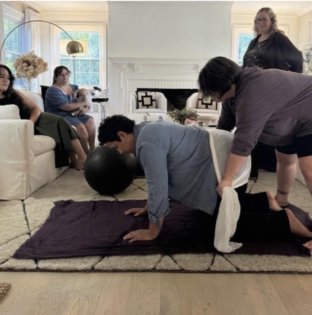 Hands-on positioning practice during a DoulaBrella training